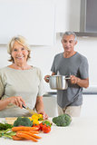 Husband bringing a pan to his smiling wife