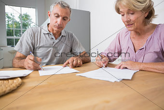 Couple signing documents together