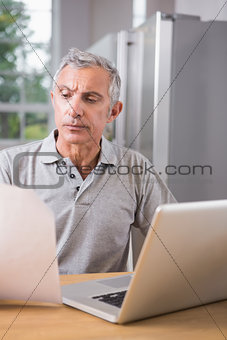 Thoughtful man using his laptop