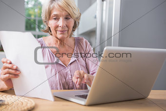 Stern mature woman using her laptop