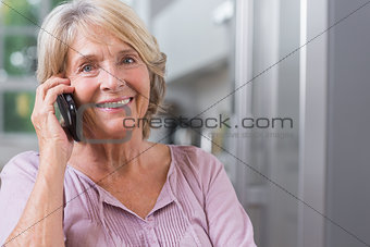 Happy mature woman calling