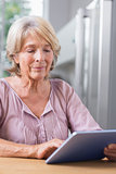 Mature woman using her digital tablet