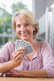 Smiling woman playing cards