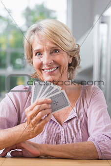 Smiling woman playing cards