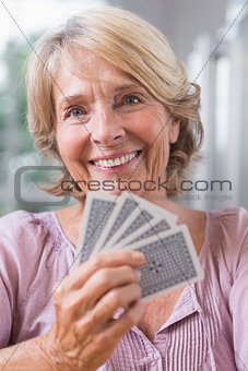 Close up of a smiling woman playing cards