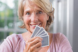 Close up of a happy woman playing cards