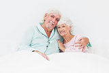 Smiling couple in bed