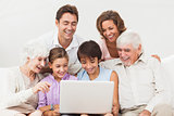 Extended family looking at laptop