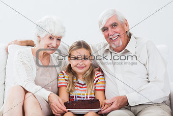 Little girl celebrating birthday with grandparents