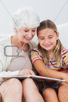 Little girl reading with granny