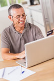 Man online shopping with laptop