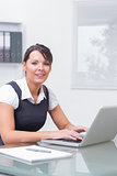Woman working on her computer with smile