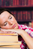 Girl sleeping on books