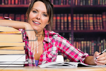 Woman leaning on books with a smile