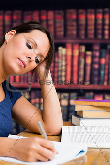 Cute girl writing with book