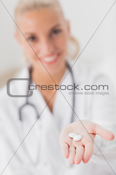 Doctor holding out tablets