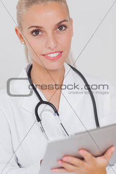 Happy doctor using tablet