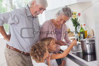 Children cooking with grandparents