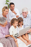 Extended family watching laptop