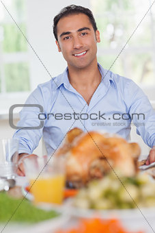 Man sitting at head of dinner table