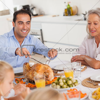 Man carving the thanksgiving turkey