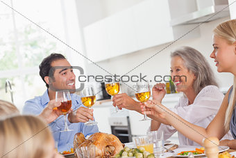 Family raising their glasses at thanksgiving dinner