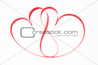 Pink ribbon shaped into intertwining hearts