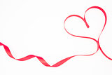 Pink ribbon shaped into heart with copy space