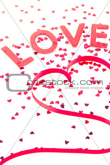 Love and heart shaped ribbon with pink confetti