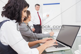 Businesswoman using a laptop during a conference