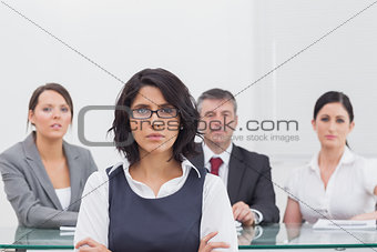 Four business people with serious expressions