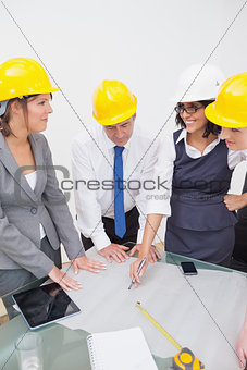 Team looking at a construction plan and laughing