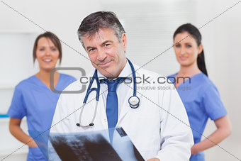 Doctor with xray and his team