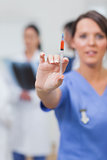 Nurse showing syringe in her hand