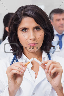 Doctor breaking a cigarette