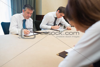 Business people writing notes
