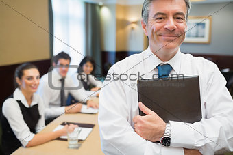 Businessman holding folder at conference