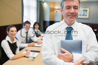 Businessman holding digital tablet at meeting