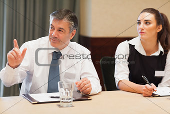 Businessman asking question in meeting