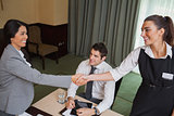 Women shaking hands during business meeting