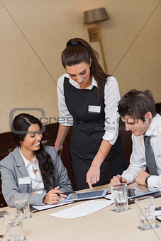 Businesswoman showing something on tablet