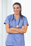 Smiling nurse with arms crossed