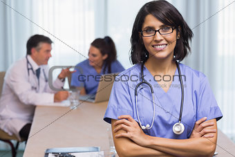 Smiling nurse with arms crossed