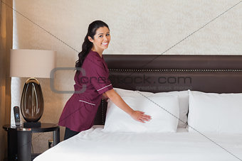 Happy hotel maid at work