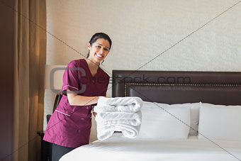 Happy maid working in hotel room