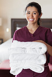 Smiling maid with towels