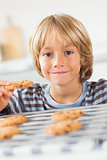 Smiling boy holding a cookie