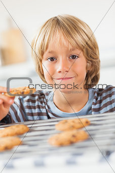 Smiling boy holding a cookie