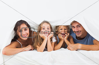 Family in the duvet smiling