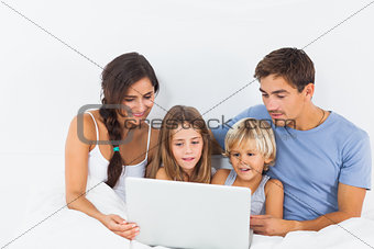 Family sitting with a laptop